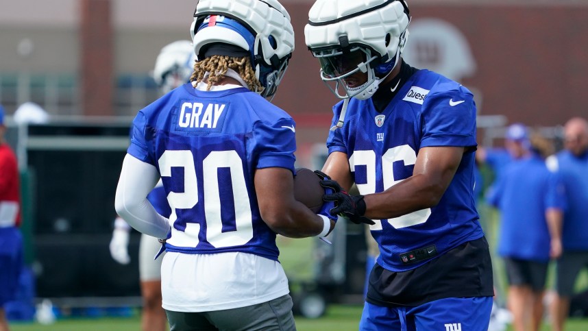 Jul 27, 2023; East Rutherford, NJ, USA;  New York Giants running back Saquon Barkley (26) works with rookie running back Eric Gray (20) on day two of training camp at the Quest Diagnostics Training Facility. Mandatory Credit: Danielle Parhizkaran-USA TODAY Sports