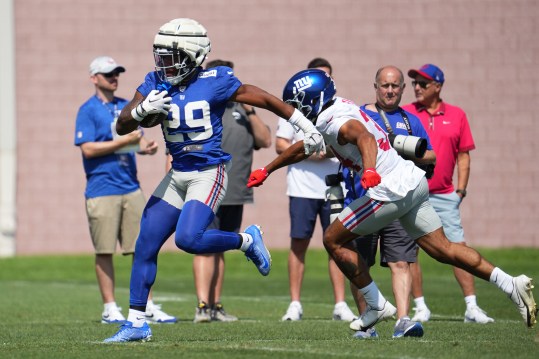 Jul 26, 2024; East Rutherford, NJ, USA; New York Giants running back Tyrone Tracy Jr. (29) carries as New York Giants defensive back Elijah Riley (34) follows during training camp at Quest Diagnostics Training Center. Mandatory Credit: Lucas Boland-USA TODAY Sports