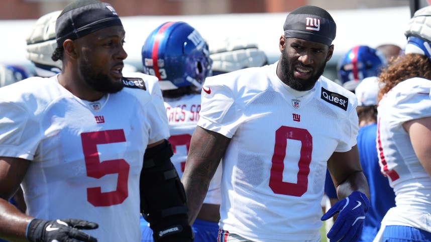 Jul 26, 2024; East Rutherford, NJ, USA; New York Giants linebacker Kayvon Thibodeaux (5) and New York Giants linebacker Brian Burns (0) break on the sideline during training camp at Quest Diagnostics Training Center. Mandatory Credit: Lucas Boland-USA TODAY Sports