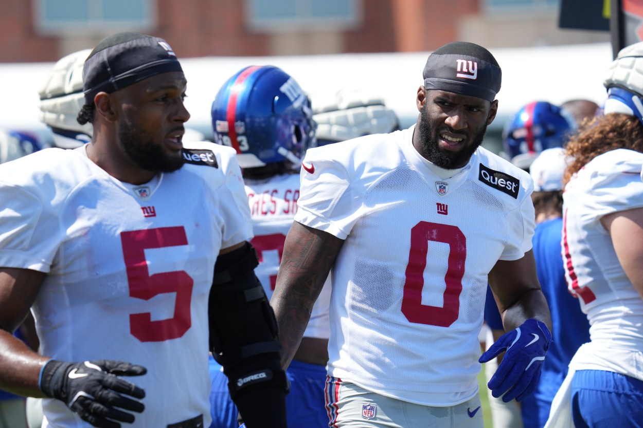 Jul 26, 2024; East Rutherford, NJ, USA; New York Giants linebacker Kayvon Thibodeaux (5) and New York Giants linebacker Brian Burns (0) break on the sideline during training camp at Quest Diagnostics Training Center. Mandatory Credit: Lucas Boland-USA TODAY Sports