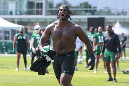 Jul 27, 2024; Florham Park, NJ, USA; New York Jets offensive tackle Olu Fashanu (74) runs up field greeting fans during training camp at Atlantic Health Jets Training Center. Mandatory Credit: Vincent Carchietta-USA TODAY Sports