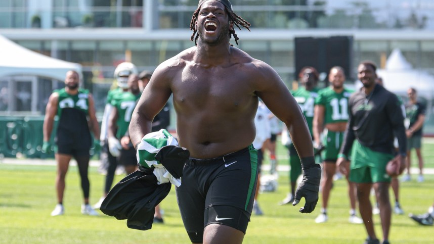 Jul 27, 2024; Florham Park, NJ, USA; New York Jets offensive tackle Olu Fashanu (74) runs up field greeting fans during training camp at Atlantic Health Jets Training Center. Mandatory Credit: Vincent Carchietta-USA TODAY Sports