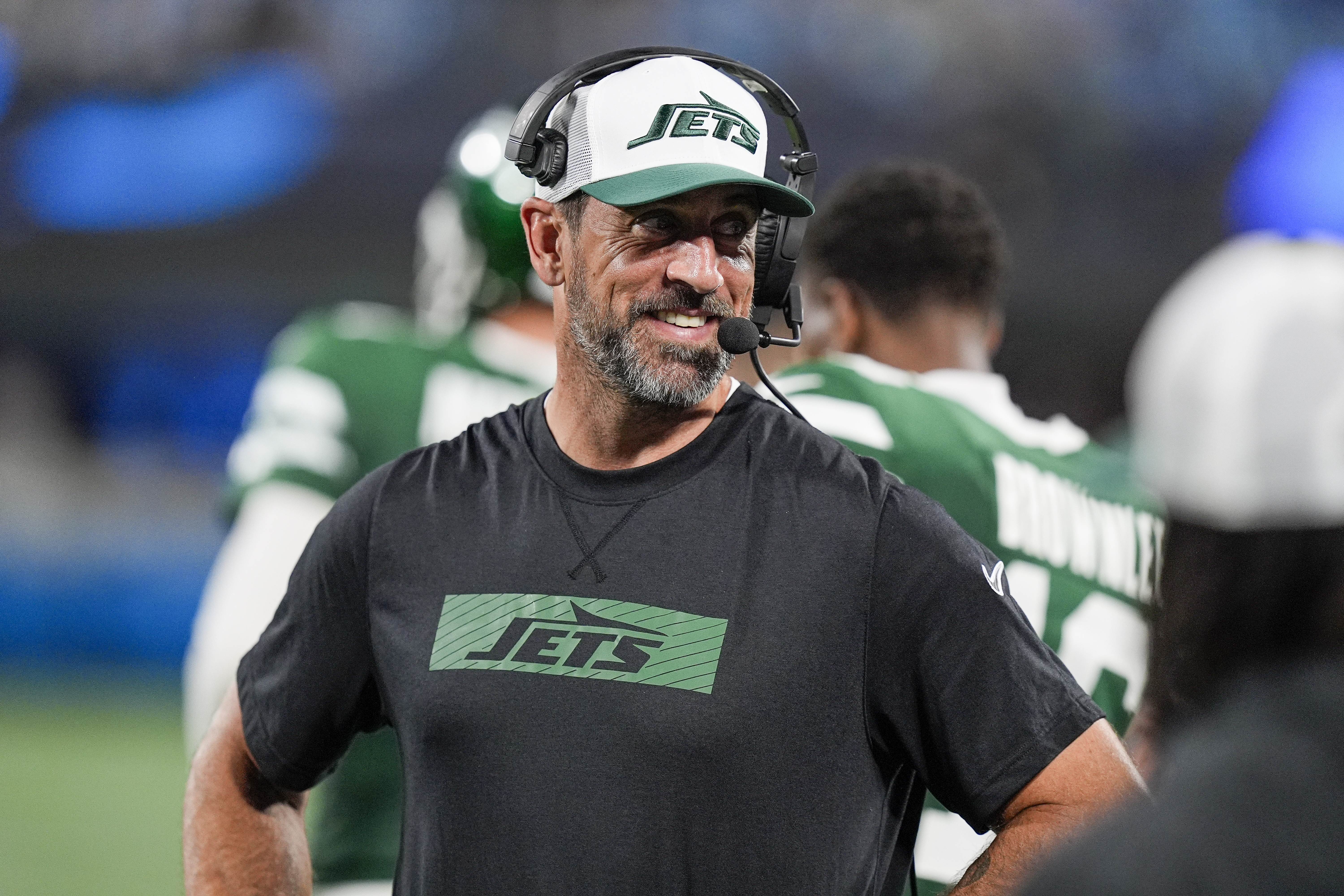 Aug 17, 2024; Charlotte, North Carolina, USA; New York Jets quarterback Aaron Rodgers (8) shares a laugh on the sidelines during the second half against the Carolina Panthers at Bank of America Stadium. Mandatory Credit: Jim Dedmon-USA TODAY Sports