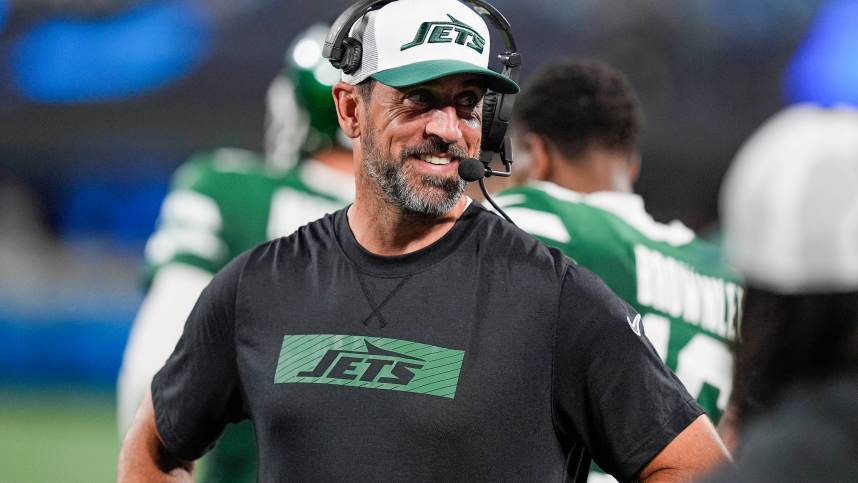 Aug 17, 2024; Charlotte, North Carolina, USA; New York Jets quarterback Aaron Rodgers (8) shares a laugh on the sidelines during the second half against the Carolina Panthers at Bank of America Stadium. Mandatory Credit: Jim Dedmon-USA TODAY Sports