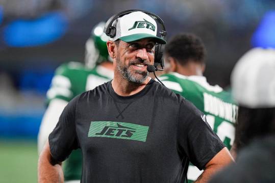 Aug 17, 2024; Charlotte, North Carolina, USA; New York Jets quarterback Aaron Rodgers (8) shares a laugh on the sidelines during the second half against the Carolina Panthers at Bank of America Stadium. Mandatory Credit: Jim Dedmon-USA TODAY Sports