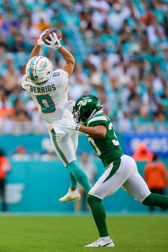 Dec 17, 2023; Miami Gardens, Florida, USA; Miami Dolphins wide receiver Braxton Berrios (0) catches the football against New York Jets cornerback Michael Carter II (30) during the second quarter at Hard Rock Stadium. Mandatory Credit: Sam Navarro-USA TODAY Sports