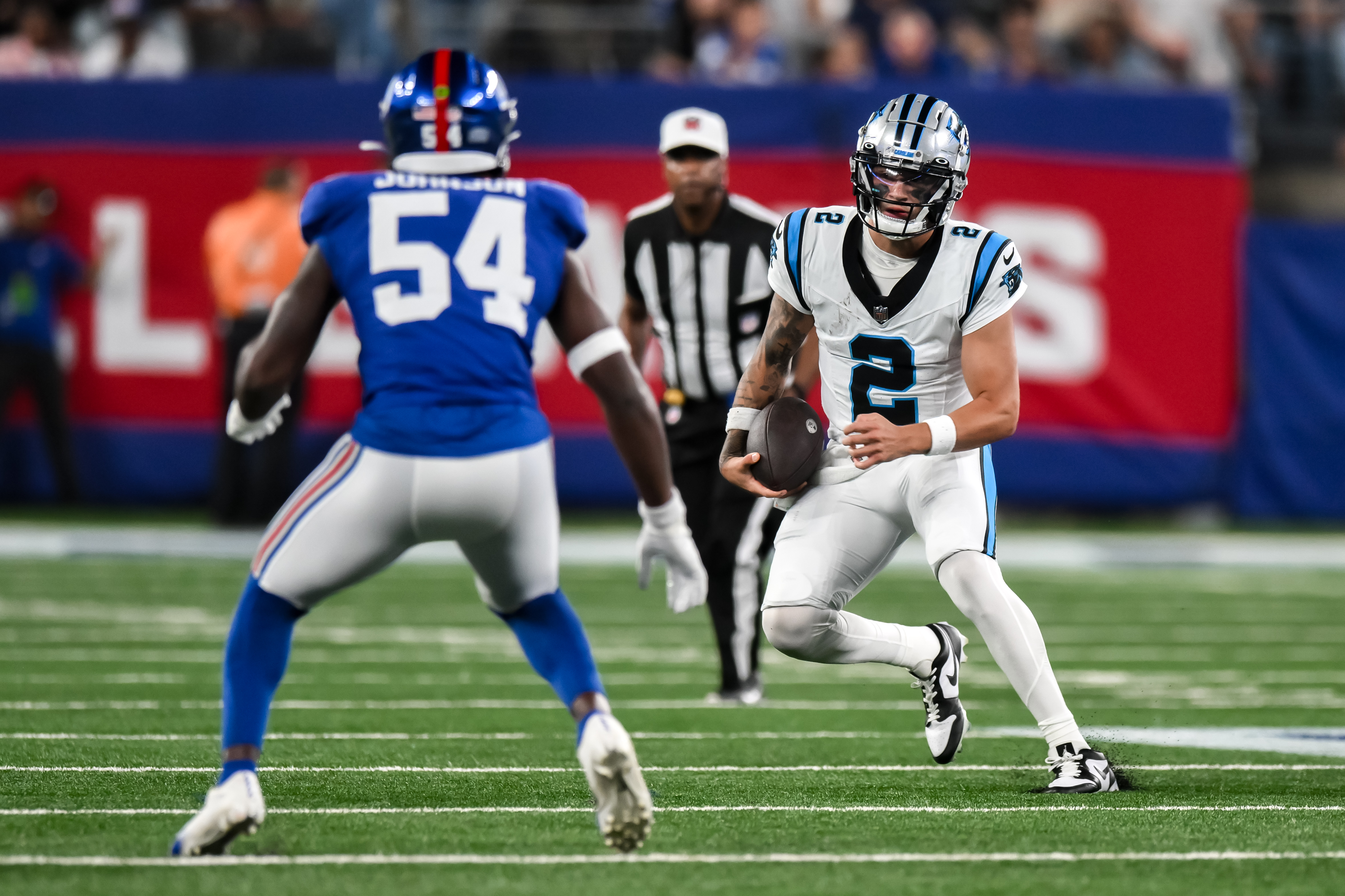 Aug 18, 2023; East Rutherford, New Jersey, USA; Carolina Panthers quarterback Matt Corral (2) tries to get past New York Giants linebacker Dyontae Johnson (54) during the third quarter at MetLife Stadium. Mandatory Credit: John Jones-USA TODAY Sports