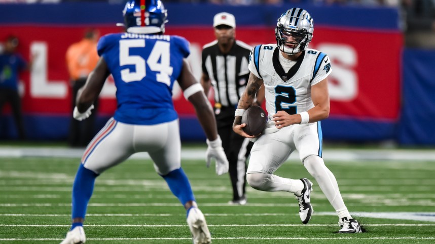 Aug 18, 2023; East Rutherford, New Jersey, USA; Carolina Panthers quarterback Matt Corral (2) tries to get past New York Giants linebacker Dyontae Johnson (54) during the third quarter at MetLife Stadium. Mandatory Credit: John Jones-USA TODAY Sports