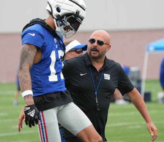 East Rutherford, NJ -- July 24, 2024 -- Wide receiver Jalin Hyatt and head coach Brian Daboll during the first day of training camp for the 2024 New York Giants.