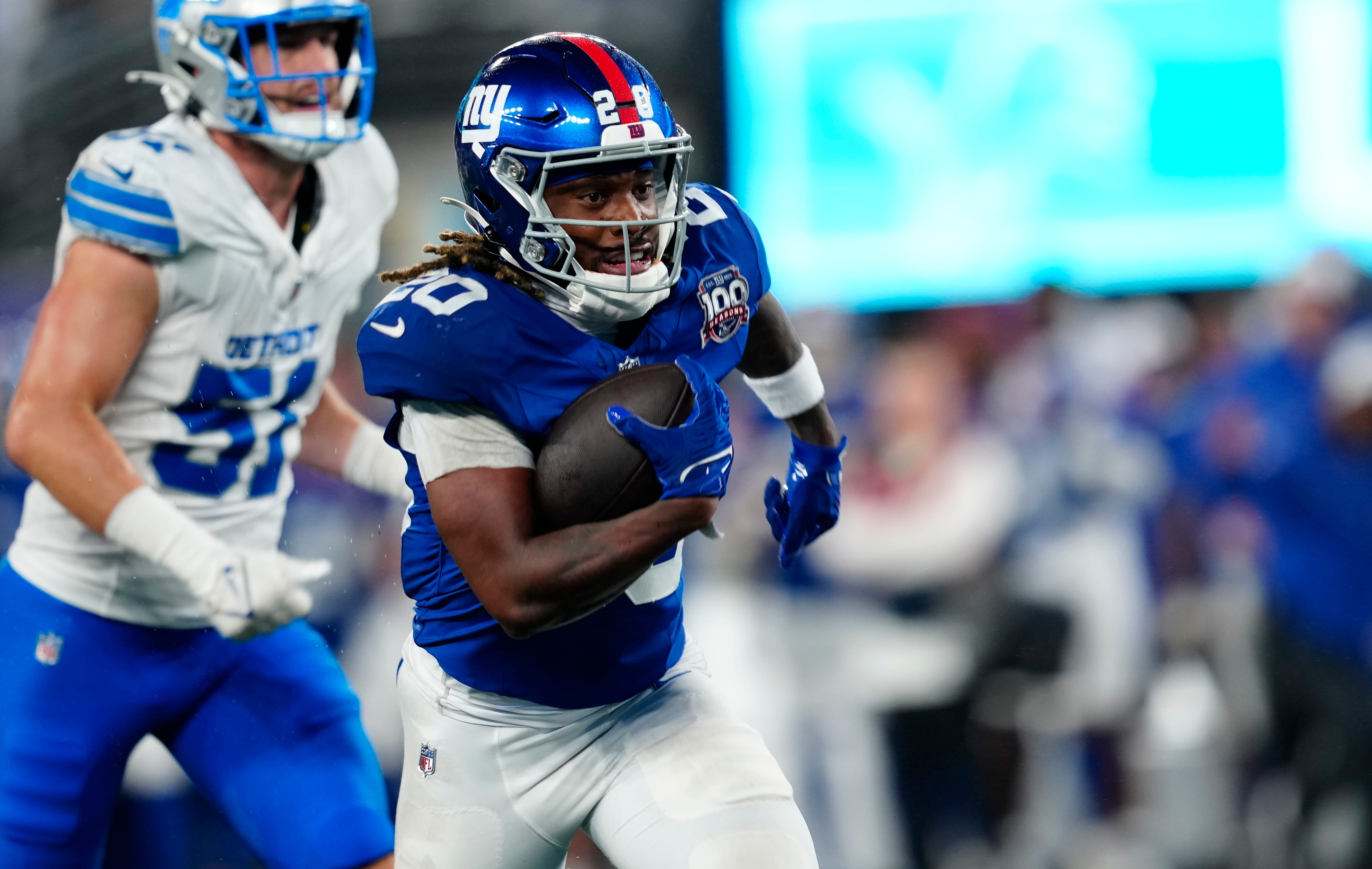 New York Giants running back Eric Gray (20) runs towards the end zone for the first touchdown of the game,, Thursday, August 8 2024, in East Rutherford.