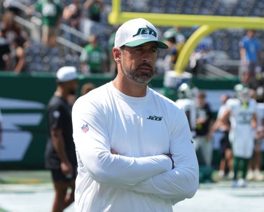 East Rutherford, NJ -- August 10, 2024 -- Aaron Rodgers, who wasn't dressed to play, during pre game warm ups as the Washington Commanders came to MetLife Stadium to play the New York Jets in the first preseason game of the 2024 season.