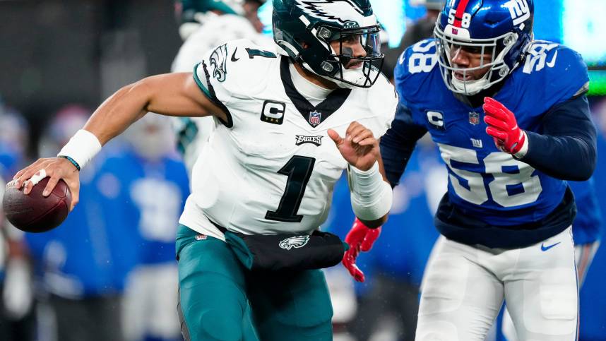 New York Giants linebacker Bobby Okereke (58) goes after Philadelphia Eagles quarterback Jalen Hurts (1) just before sacking him in the second quarter, Sunday, January 7, 2024.