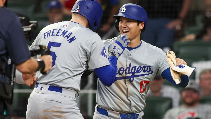 Sep 16, 2024; Atlanta, Georgia, USA; Los Angeles Dodgers first baseman Freddie Freeman (5) celebrates with designated hitter Shohei Ohtani (17) after a three-run home run against the Atlanta Braves in the seventh inning at Truist Park. Mandatory Credit: Brett Davis-Imagn Images