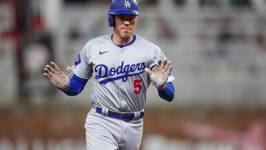 Sep 16, 2024; Atlanta, Georgia, USA; Los Angeles Dodgers first baseman Freddie Freeman (5) celebrates after a three-run home run against the Atlanta Braves in the seventh inning at Truist Park. Mandatory Credit: Brett Davis-Imagn Images