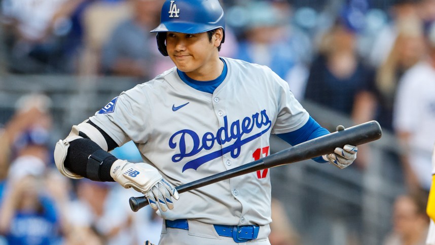 Jul 30, 2024; San Diego, California, USA;  Los Angeles Dodgers designated hitter Shohei Ohtani (17) looks into the San Diego Padres dugout before his at bat during the first inning at Petco Park. Mandatory Credit: David Frerker-Imagn Images