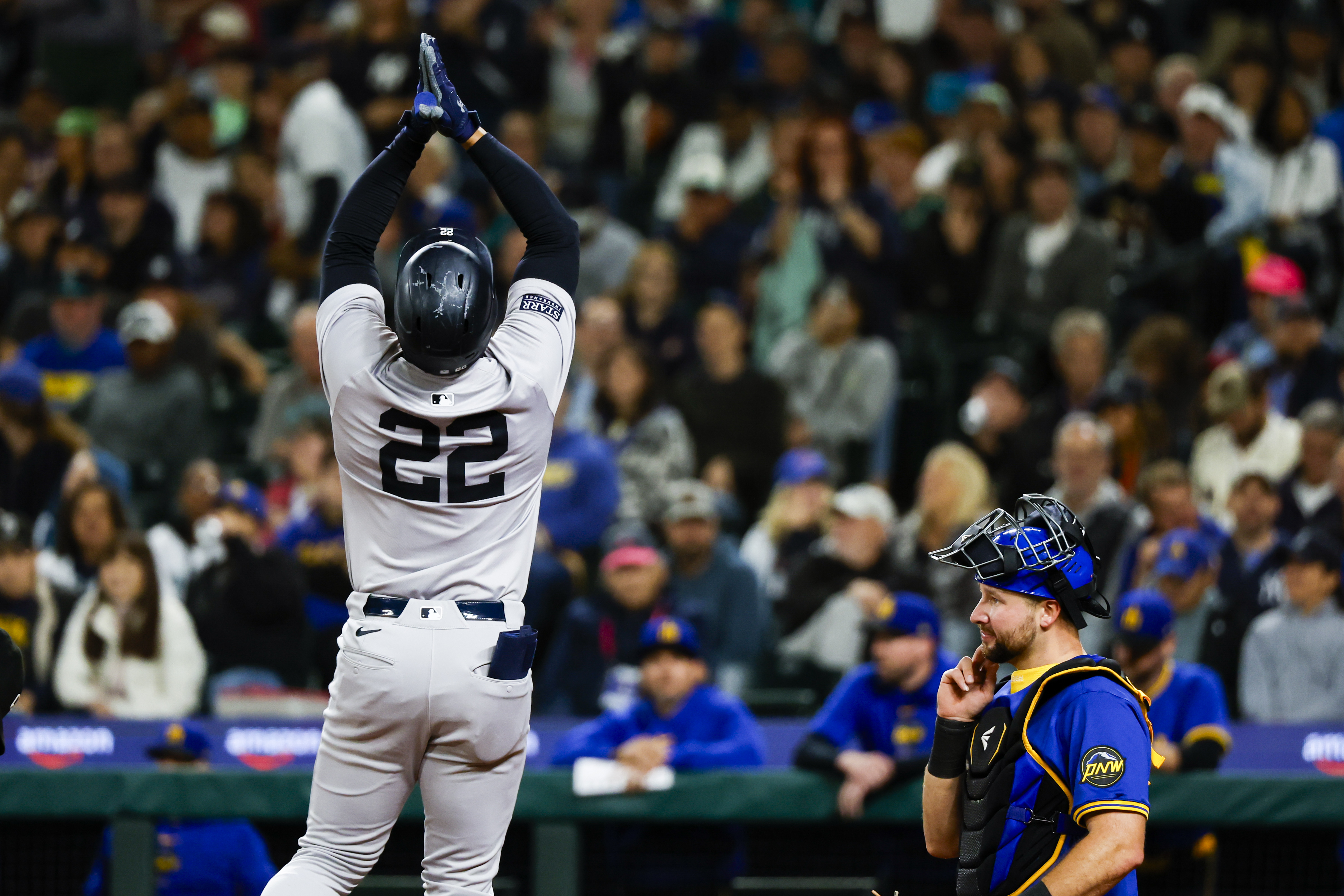 Sep 17, 2024; Seattle, Washington, USA; New York Yankees right fielder Juan Soto (22) celebrates a two-run home run against the Seattle Mariners during the fourth inning at T-Mobile Park. Seattle Mariners catcher Cal Raleigh (29) reacts at right. Mandatory Credit: Joe Nicholson-Imagn Images