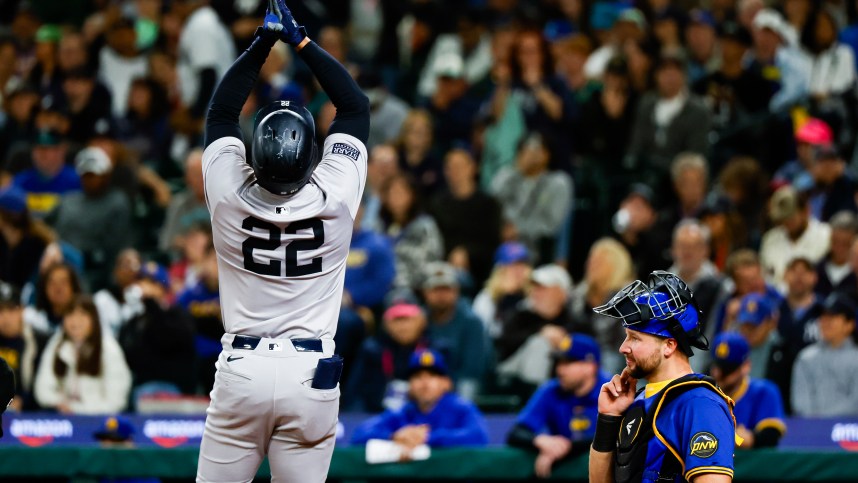 Sep 17, 2024; Seattle, Washington, USA; New York Yankees right fielder Juan Soto (22) celebrates a two-run home run against the Seattle Mariners during the fourth inning at T-Mobile Park. Seattle Mariners catcher Cal Raleigh (29) reacts at right. Mandatory Credit: Joe Nicholson-Imagn Images