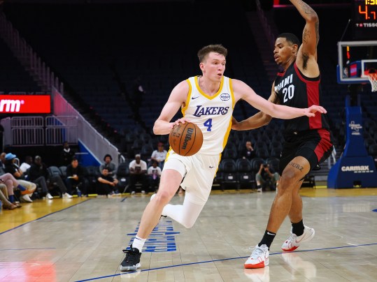 Jul 10, 2024; San Francisco, CA, USA; Los Angeles Lakers guard Dalton Knecht (4) drives against Miami Heat forward Keshad Johnson (20) during the third quarter at Chase Center. Mandatory Credit: Kelley L Cox-Imagn Images