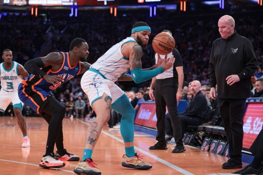 Nov 28, 2023; New York, New York, USA; Charlotte Hornets forward Miles Bridges (0) is guarded by New York Knicks forward Julius Randle (30) in front of head coach Steve Clifford during the second half at Madison Square Garden. Mandatory Credit: Vincent Carchietta-Imagn Images