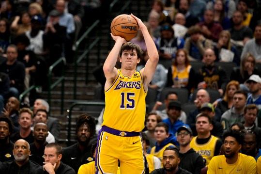 Dec 12, 2023; Dallas, Texas, USA; Los Angeles Lakers guard Austin Reaves (15) makes a three point shot against the Dallas Mavericks during the second quarter at the American Airlines Center. Mandatory Credit: Jerome Miron-Imagn Images