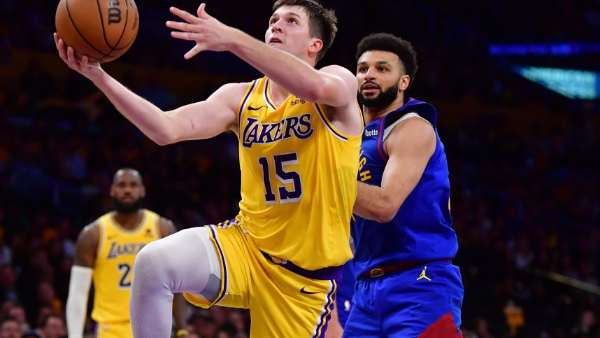 Apr 25, 2024; Los Angeles, California, USA; Los Angeles Lakers guard Austin Reaves (15) shoots ahead of Denver Nuggets guard Jamal Murray (27) during the second half in game three of the first round for the 2024 NBA playoffs at Crypto.com Arena. Mandatory Credit: Gary A. Vasquez-Imagn Images