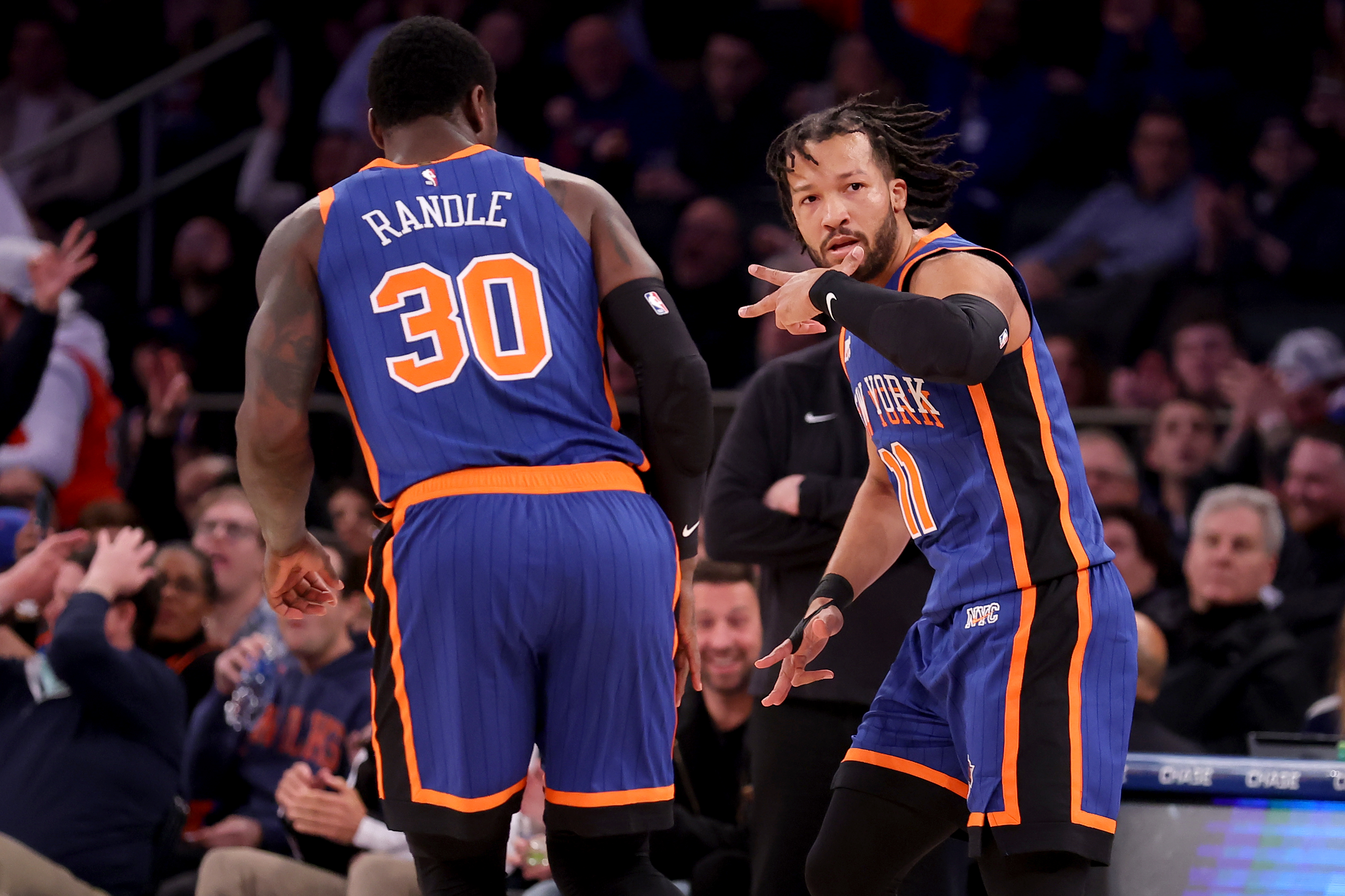 Jan 20, 2024; New York, New York, USA; New York Knicks guard Jalen Brunson (11) celebrates his three point shot against the Toronto Raptors with forward Julius Randle (30) during the first quarter at Madison Square Garden. Mandatory Credit: Brad Penner-Imagn Images