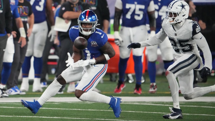 Sep 26, 2024; East Rutherford, New Jersey, USA;  New York Giants wide receiver Malik Nabers (1) gathers in a pass in front of Dallas Cowboys cornerback Andrew Booth Jr. (25) in the first half at MetLife Stadium. Mandatory Credit: Robert Deutsch-Imagn Images