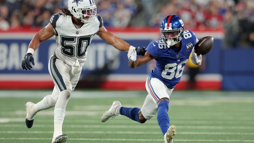 Sep 26, 2024; East Rutherford, New Jersey, USA; New York Giants wide receiver Darius Slayton (86) bobbles the ball as he runs against Dallas Cowboys linebacker Eric Kendricks (50) during the second quarter at MetLife Stadium. Mandatory Credit: Brad Penner-Imagn Images