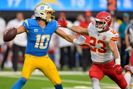 Sep 29, 2024; Inglewood, California, USA;  Los Angeles Chargers quarterback Justin Herbert (10) throws an incomplete pas as is pressured by Kansas City Chiefs linebacker Drue Tranquill (23) at SoFi Stadium. Mandatory Credit: Jayne Kamin-Oncea-Imagn Images