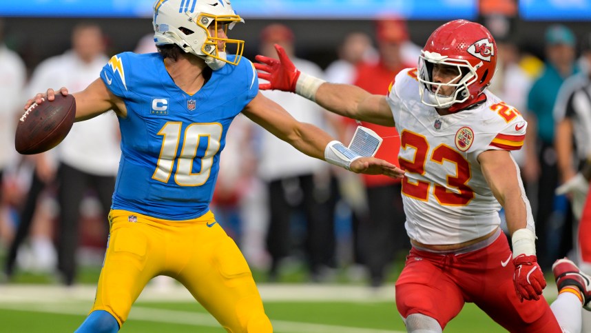 Sep 29, 2024; Inglewood, California, USA;  Los Angeles Chargers quarterback Justin Herbert (10) throws an incomplete pas as is pressured by Kansas City Chiefs linebacker Drue Tranquill (23) at SoFi Stadium. Mandatory Credit: Jayne Kamin-Oncea-Imagn Images