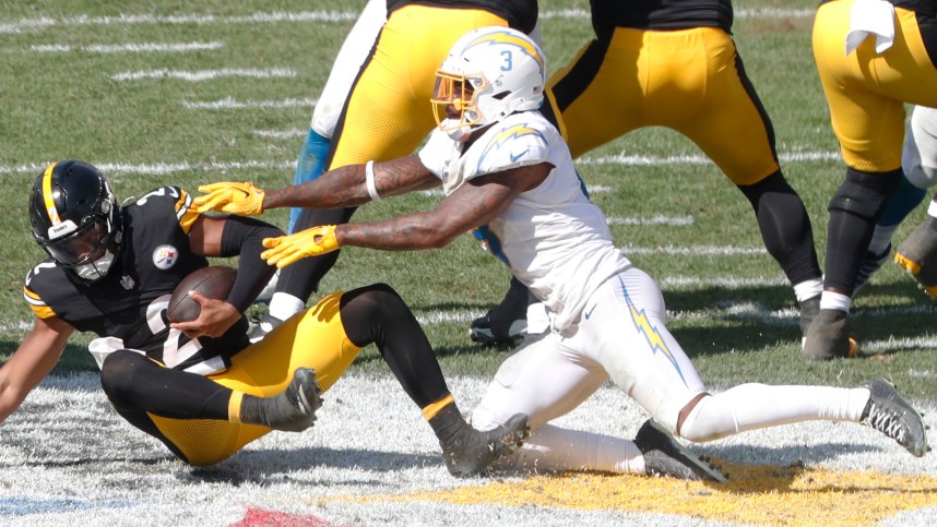 Sep 22, 2024; Pittsburgh, Pennsylvania, USA;  Los Angeles Chargers safety Derwin James Jr. (3) sacks Pittsburgh Steelers quarterback Justin Fields (2) during the third quarter at Acrisure Stadium. Pittsburgh won 20-10. Mandatory Credit: Charles LeClaire-Imagn Images