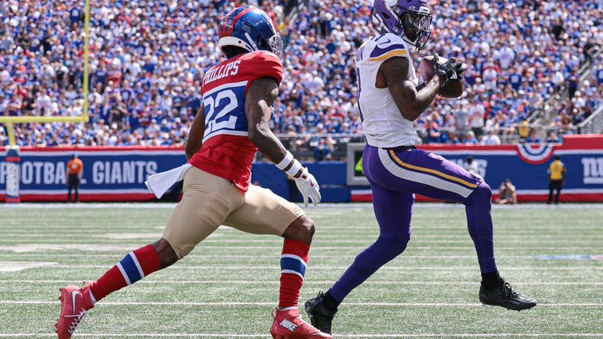 Sep 8, 2024; East Rutherford, New Jersey, USA; Minnesota Vikings wide receiver Jordan Addison (3) catches the ball in front of New York Giants cornerback Dru Phillips (22) during the first half at MetLife Stadium. Mandatory Credit: Vincent Carchietta-Imagn Images