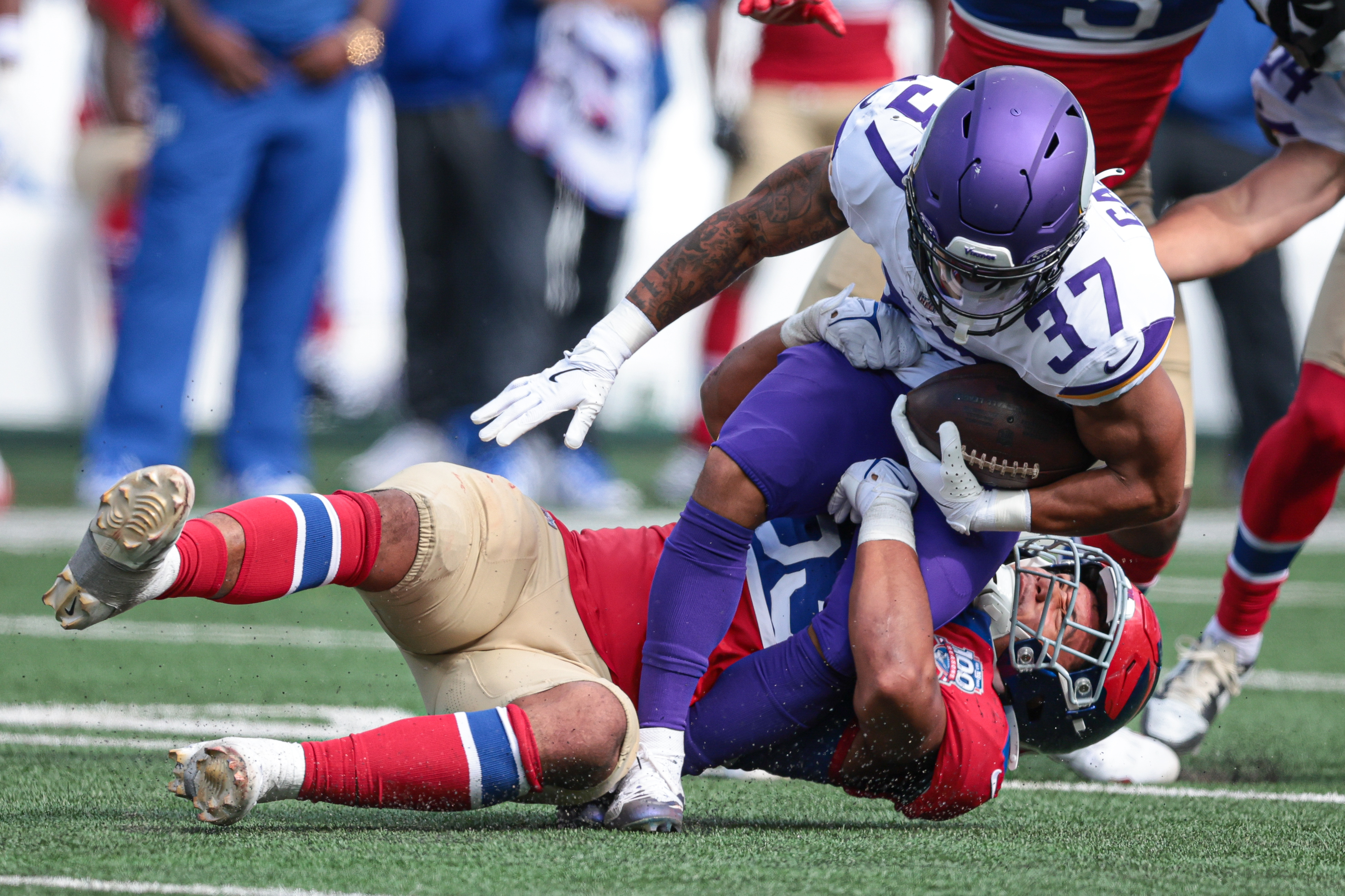 Sep 8, 2024; East Rutherford, New Jersey, USA; Minnesota Vikings running back Miles Gaskin (37) is tackled by New York Giants linebacker Darius Muasau (53) during the second half at MetLife Stadium. Mandatory Credit: Vincent Carchietta-Imagn Images