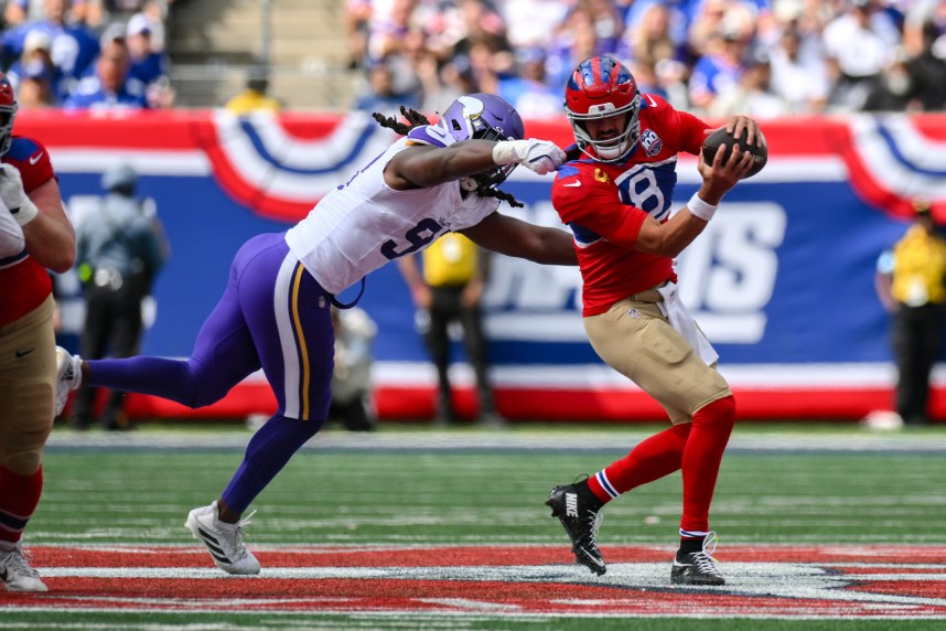 Sep 8, 2024; East Rutherford, New Jersey, USA; New York Giants quarterback Daniel Jones (8) is pressured by Minnesota Vikings linebacker Pat Jones II (91) during the second half at MetLife Stadium. Mandatory Credit: John Jones-Imagn Images