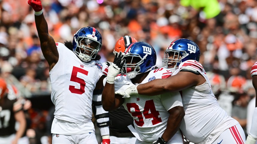 Sep 22, 2024; Cleveland, Ohio, USA; New York Giants linebacker Kayvon Thibodeaux (5) and defensive tackle Elijah Chatman (94) and defensive tackle Dexter Lawrence II (97) celebrate after sacking Cleveland Browns quarterback Deshaun Watson (not pictured) during the first quarter at Huntington Bank Field. Mandatory Credit: Ken Blaze-Imagn Images