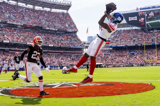 Sep 22, 2024; Cleveland, Ohio, USA; New York Giants wide receiver Malik Nabers (1) makes a touchdown reception under coverage by Cleveland Browns cornerback Martin Emerson Jr. (23) during the second quarter at Huntington Bank Field. Mandatory Credit: Scott Galvin-Imagn Images