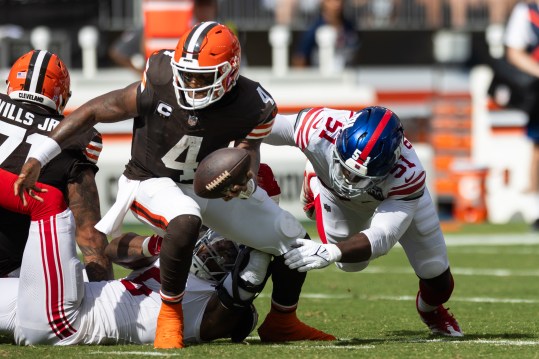 Sep 22, 2024; Cleveland, Ohio, USA; Cleveland Browns quarterback Deshaun Watson (4) runs the ball as New York Giants linebacker Azeez Ojulari (51) tackles him during the third quarter at Huntington Bank Field. Mandatory Credit: Scott Galvin-Imagn Images