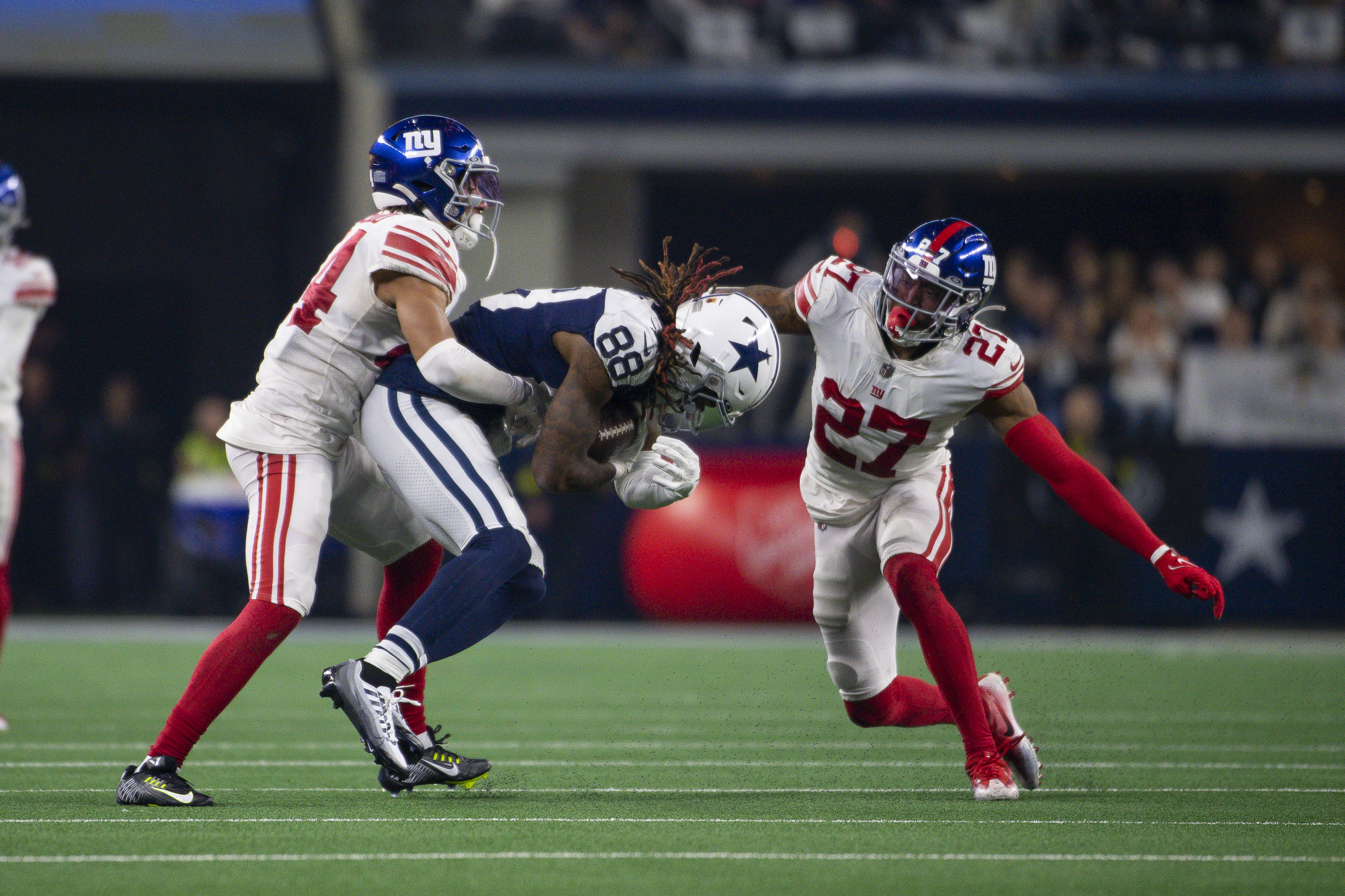 Nov 24, 2022; Arlington, Texas, USA; Dallas Cowboys wide receiver CeeDee Lamb (88) and New York Giants cornerback Nick McCloud (44) and cornerback Jason Pinnock (27) in action during the game between the Dallas Cowboys and the New York Giants at AT&T Stadium. Mandatory Credit: Jerome Miron-Imagn Images