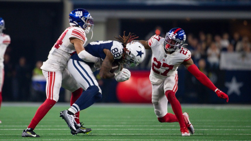 Nov 24, 2022; Arlington, Texas, USA; Dallas Cowboys wide receiver CeeDee Lamb (88) and New York Giants cornerback Nick McCloud (44) and cornerback Jason Pinnock (27) in action during the game between the Dallas Cowboys and the New York Giants at AT&T Stadium. Mandatory Credit: Jerome Miron-Imagn Images