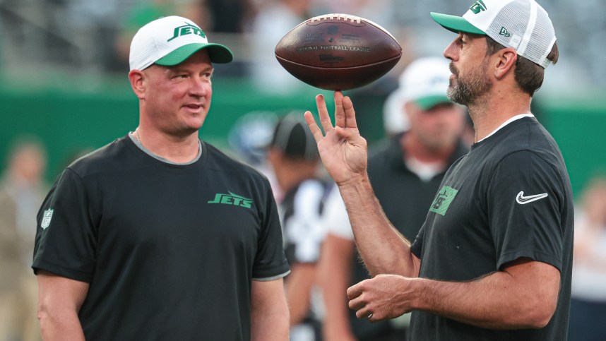 Aug 24, 2024; East Rutherford, New Jersey, USA; New York Jets quarterback Aaron Rodgers (left) spins the ball in front of offensive coordinator Nathaniel Hackett before the game against the New York Giants at MetLife Stadium. Mandatory Credit: Vincent Carchietta-Imagn Images