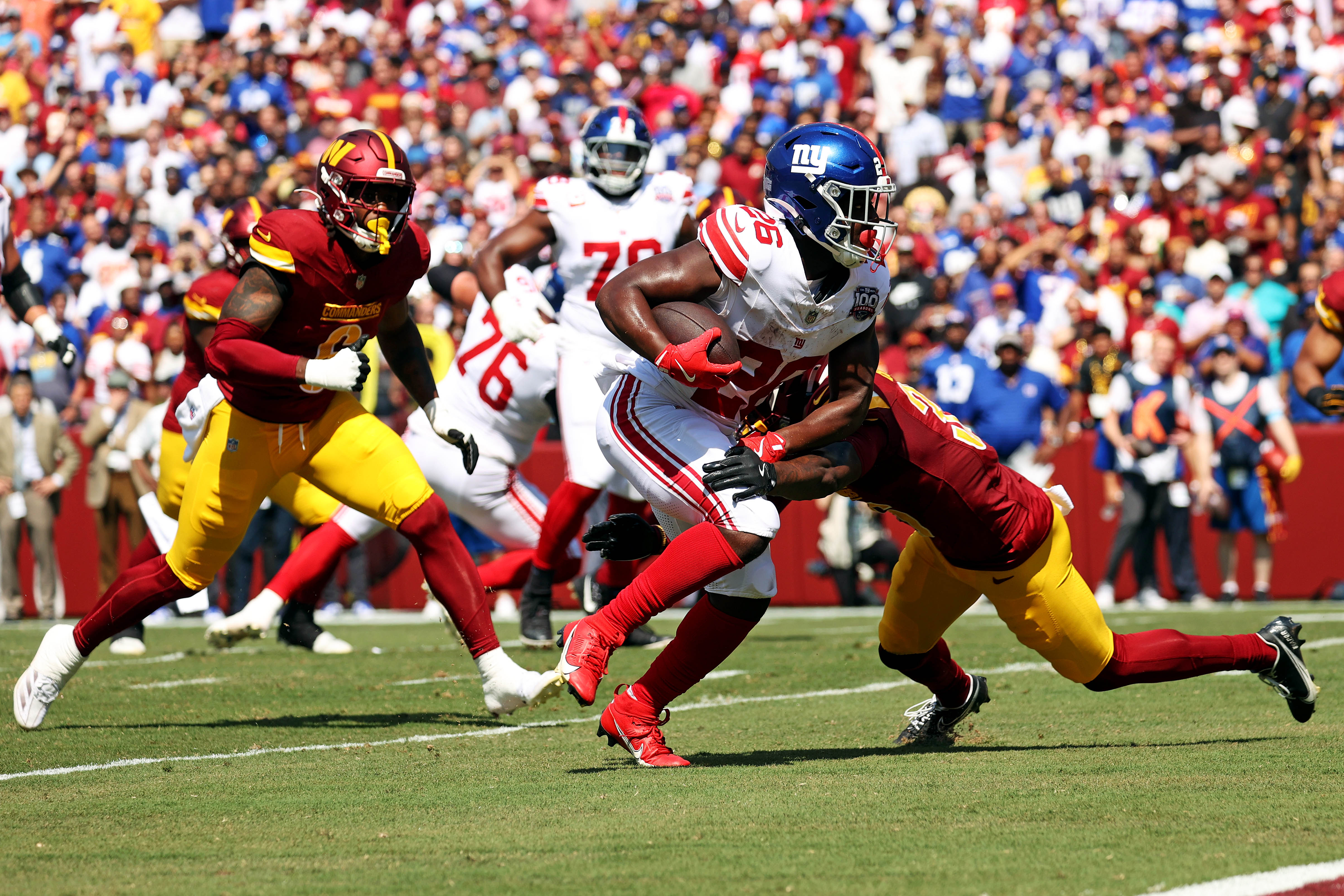 Sep 15, 2024; Landover, Maryland, USA; New York Giants running back Devin Singletary (26) runs for a touchdown during the first quarter against the Washington Commanders at Commanders Field. Mandatory Credit: Peter Casey-Imagn Images