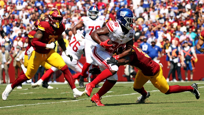 Sep 15, 2024; Landover, Maryland, USA; New York Giants running back Devin Singletary (26) runs for a touchdown during the first quarter against the Washington Commanders at Commanders Field. Mandatory Credit: Peter Casey-Imagn Images