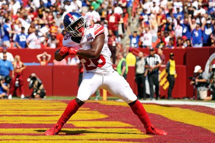 Sep 15, 2024; Landover, Maryland, USA; New York Giants running back Devin Singletary (26) celebrates after scoring a touchdown during the first quarter against the Washington Commanders at Commanders Field. Mandatory Credit: Peter Casey-Imagn Images