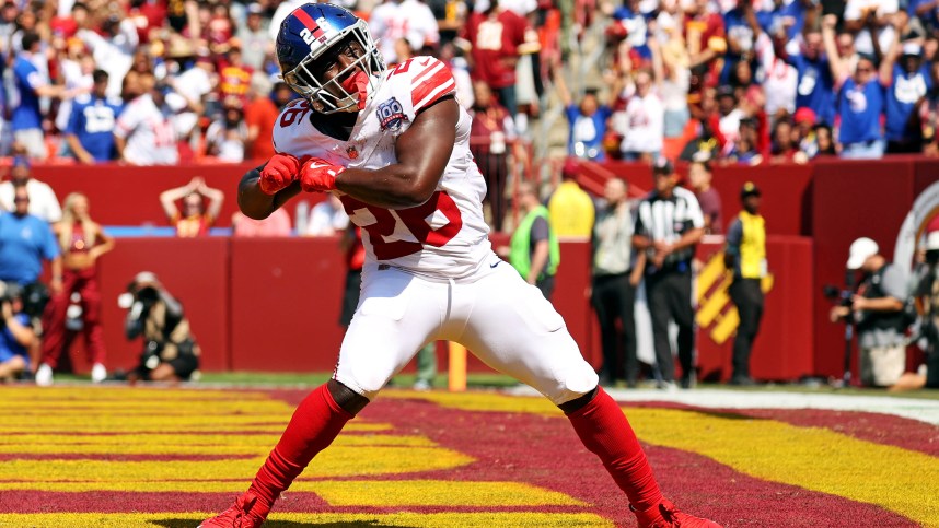 Sep 15, 2024; Landover, Maryland, USA; New York Giants running back Devin Singletary (26) celebrates after scoring a touchdown during the first quarter against the Washington Commanders at Commanders Field. Mandatory Credit: Peter Casey-Imagn Images