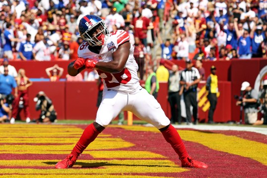 Sep 15, 2024; Landover, Maryland, USA; New York Giants running back Devin Singletary (26) celebrates after scoring a touchdown during the first quarter against the Washington Commanders at Commanders Field. Mandatory Credit: Peter Casey-Imagn Images