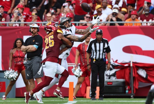 Sep 8, 2024; Tampa, Florida, USA;  Tampa Bay Buccaneers wide receiver Mike Evans (13) catches the ball for a touchdown over Washington Commanders cornerback Benjamin St-Juste (25) during the first half at Raymond James Stadium. Mandatory Credit: Kim Klement Neitzel-Imagn Images