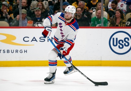 Mar 16, 2024; Pittsburgh, Pennsylvania, USA;  New York Rangers defenseman Zac Jones (6) passes the puck against the Pittsburgh Penguins during the first period at PPG Paints Arena. New York won 7-4. Mandatory Credit: Charles LeClaire-Imagn Images