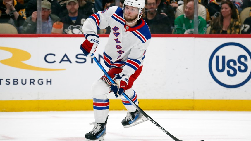 Mar 16, 2024; Pittsburgh, Pennsylvania, USA;  New York Rangers defenseman Zac Jones (6) passes the puck against the Pittsburgh Penguins during the first period at PPG Paints Arena. New York won 7-4. Mandatory Credit: Charles LeClaire-Imagn Images