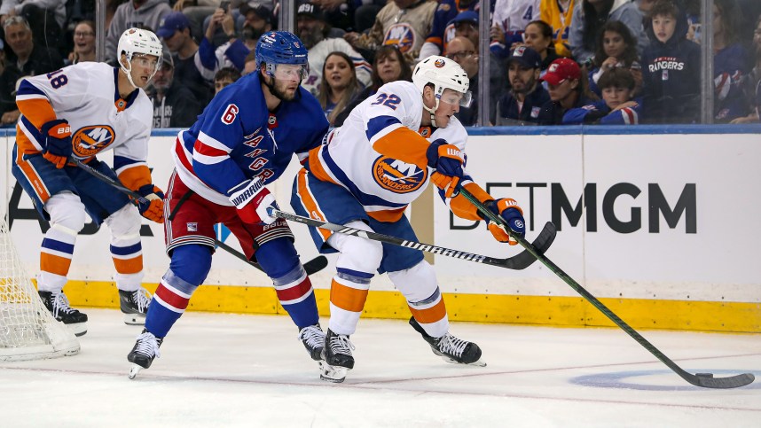 Sep 24, 2024; New York, New York, USA; New York Islanders center Kyle McLean (32) is defended by New York Rangers defenseman Zac Jones (6) during the second period at Madison Square Garden. Mandatory Credit: Danny Wild-Imagn Images