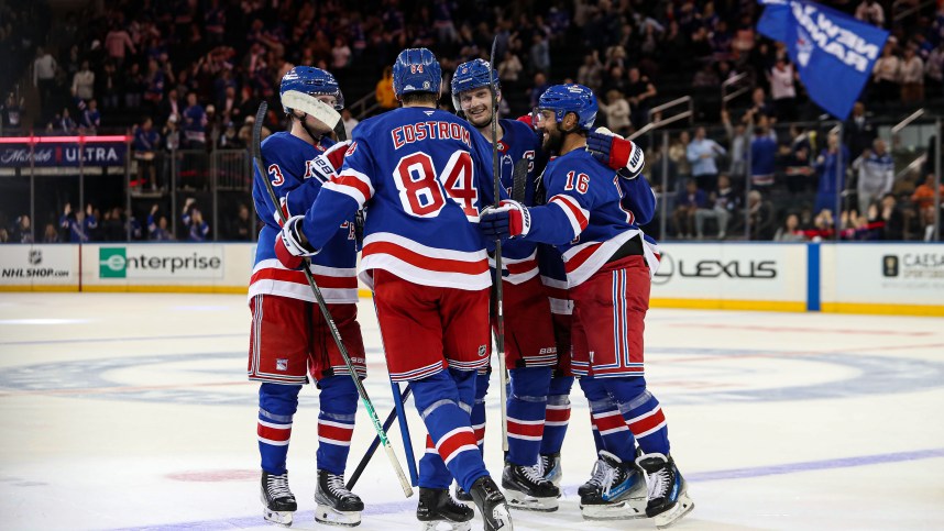 Sep 24, 2024; New York, New York, USA; New York Rangers center Adam Edstrom (84) celebrates game-winner goal with defenseman Jacob Trouba (8) and center Vincent Trocheck (16) during the third period against the New York Islanders at Madison Square Garden. Mandatory Credit: Danny Wild-Imagn Images